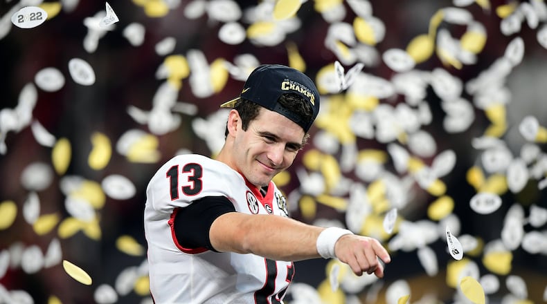 Stetson Bennett #13 of the Georgia Bulldogs celebrates after the Georgia Bulldogs defeated the Alabama Crimson Tide 33-18 during the 2022 CFP National Championship Game at Lucas Oil Stadium on Jan. 10, 2022, in Indianapolis, Indiana. (Emilee Chinn/Getty Images/TNS)