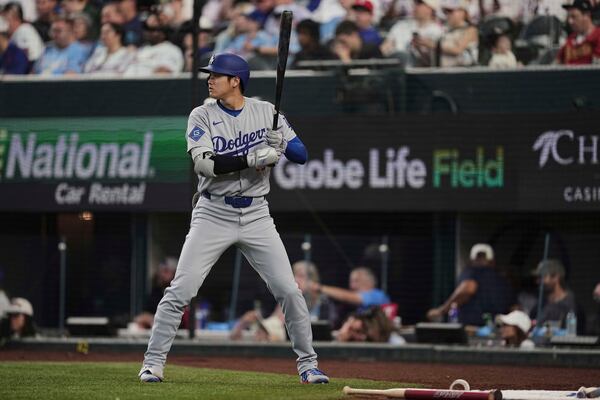 Los Angeles Dodgers' Shohei Ohtani stands on deck in the eighth inning of a baseball game against the Texas Rangers in Arlington, Texas, Sunday, April 20, 2025. (AP Photo/Tony Gutierrez)