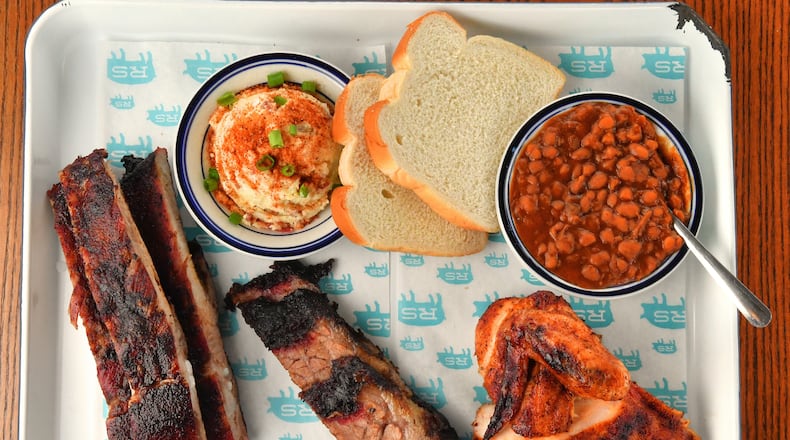 This three-meat plate at Rodney Scott's Whole Hog BBQ in southwest Atlanta has ribs, brisket and bone-in chicken, with potato salad and baked beans. (Chris Hunt for The Atlanta Journal-Constitution)