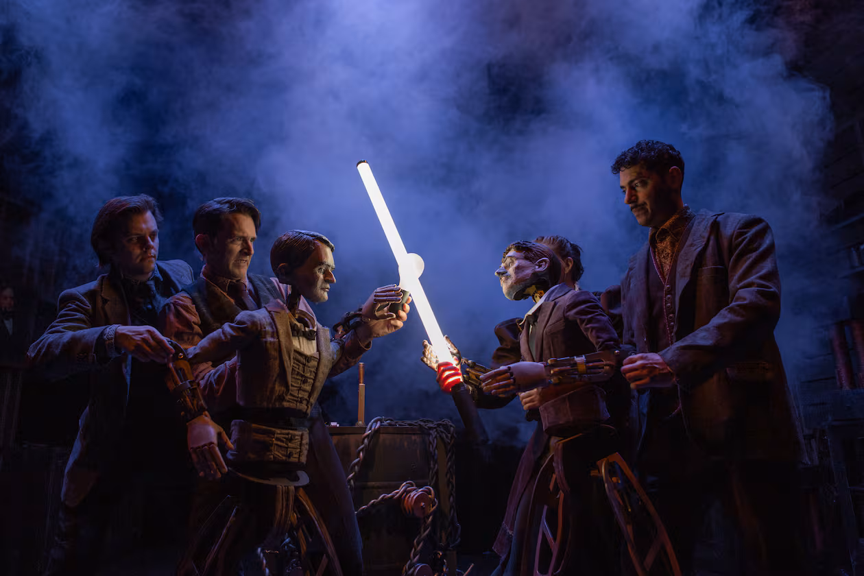 Thomas Edison, puppeteered by Alex Burnette, left, and Jason Hines in 2023, clashes with Nikola Tesla, puppeteered by Sarah Beth Hester, background, and Yankl (Jake) Krakovsky, at Niagara Falls. Performances run through Aug. 23. (Photo courtesy Center for Puppetry Arts/Stacey Bode)
