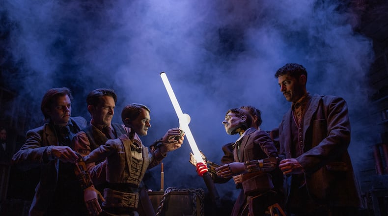 Thomas Edison, puppeteered by Alex Burnette, left, and Jason Hines in 2023, clashes with Nikola Tesla, puppeteered by Sarah Beth Hester, background, and Yankl (Jake) Krakovsky, at Niagara Falls. Performances run through Aug. 23. (Photo courtesy Center for Puppetry Arts/Stacey Bode)