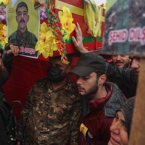 Soldiers carry coffins during the funeral of Kurdish-led Syrian Democratic Forces (SDF) fighters killed earlier this month during clashes with Syrian government forces, in Qamishli, northeastern Syria, Wednesday, Jan. 28, 2026. (AP Photo/Baderkhan Ahmad)