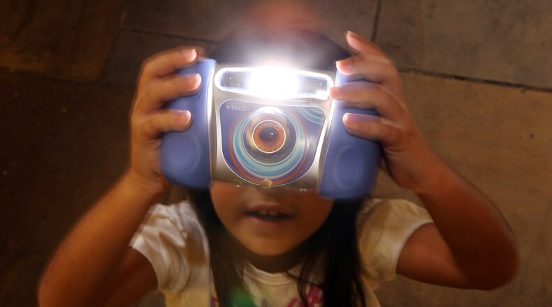 LONDON, ENGLAND - OCTOBER 28: An 8-year-old plays with the Kidizoom Multimedia Digital Camera made by V-Tech at the 'Dream Toys' fair of predicted top selling toys for Christmas on October 28, 2009 in London, England. (Photo by Oli Scarff/Getty Images)