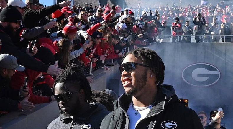 Georgia's offensive lineman Devin Willock (77) enters the stadium during the celebration of the Bulldogs going back-to-back to win the 2022 National Championship at Sanford Stadium, Saturday, Jan. 14, 2023, in Athens. Celebration turned to tragedy just hours after the University of Georgia celebrated a second straight national championship with a parade and ceremony Saturday. Georgia offensive lineman Devin Willock and football staff member Chandler LeCroy died in a car accident early Sunday morning. Two other members of the football program also were injured and are in stable condition. (Hyosub Shin / Hyosub.Shin@ajc.com)
