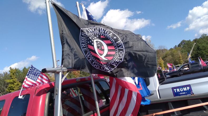 A QAnon flag flies from a truck in a pro-Trump caravan in metro Atlanta Nov. 1, 2020.