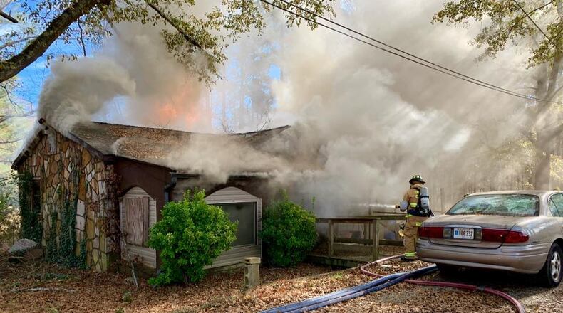 Firefighters attack the blaze on Ga. 54 Thursday.