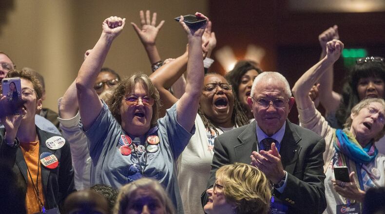 Supporters cheer Saturday during the Democratic Party of Georgia convention at the CNN Omni Hotel in Atlanta. (ALYSSA POINTER/ALYSSA.POINTER@AJC.COM)