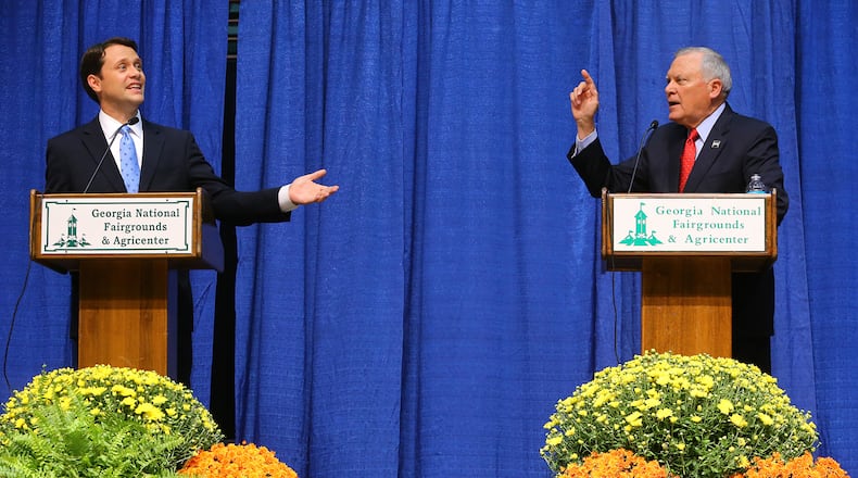 100714 PERRY: Jason Carter and Nathan Deal face off in a gubernatorial debate in Reaves Arena at the Georgia National Fair on Tuesday, Oct. 7, 2014, in Perry. CURTIS COMPTON / CCOMPTON@AJC.COM Jason Carter and Gov. Nathan Deal.