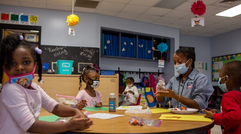 Savana Jordan, Kennedi Hill, Ms. Micahiah Drake and Reign Smith work on their art projects about autumn at Liberty Point Elementary School in Union City, Georgia, on Friday, October 16, 2020. Ms. Micahiah Drake is a first-year Pre-K techer at Liberty Point Elementary School and has had to adjust her teaching style because of the coronavirus pandemic. (Rebecca Wright for the Atlanta Journal-Constitution)