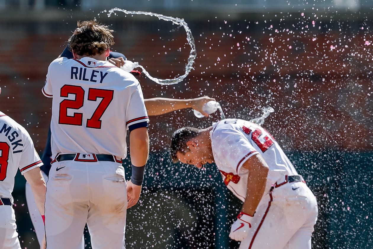 Atlanta Braves' Matt Olson, right, is doused by Austin Riley and others after he hit the winning walkoff RBI single against the Colorado Rockies during the 10th inning of a baseball game, Sunday, Aug. 30, 2026, in Atlanta. (Erik S. Lesser/AP)
