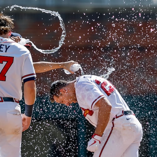 Atlanta Braves' Matt Olson, right, is doused by Austin Riley and others after he hit the winning walkoff RBI single against the Colorado Rockies during the 10th inning of a baseball game, Sunday, Aug. 30, 2026, in Atlanta. (Erik S. Lesser/AP)