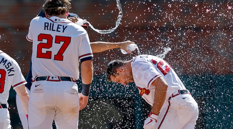Atlanta Braves' Matt Olson, right, is doused by Austin Riley and others after he hit the winning walkoff RBI single against the Colorado Rockies during the 10th inning of a baseball game, Sunday, Aug. 30, 2026, in Atlanta. (Erik S. Lesser/AP)