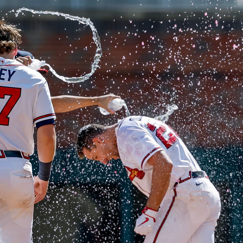 Atlanta Braves' Matt Olson, right, is doused by Austin Riley and others after he hit the winning walkoff RBI single against the Colorado Rockies during the 10th inning of a baseball game, Sunday, Aug. 30, 2026, in Atlanta. (Erik S. Lesser/AP)