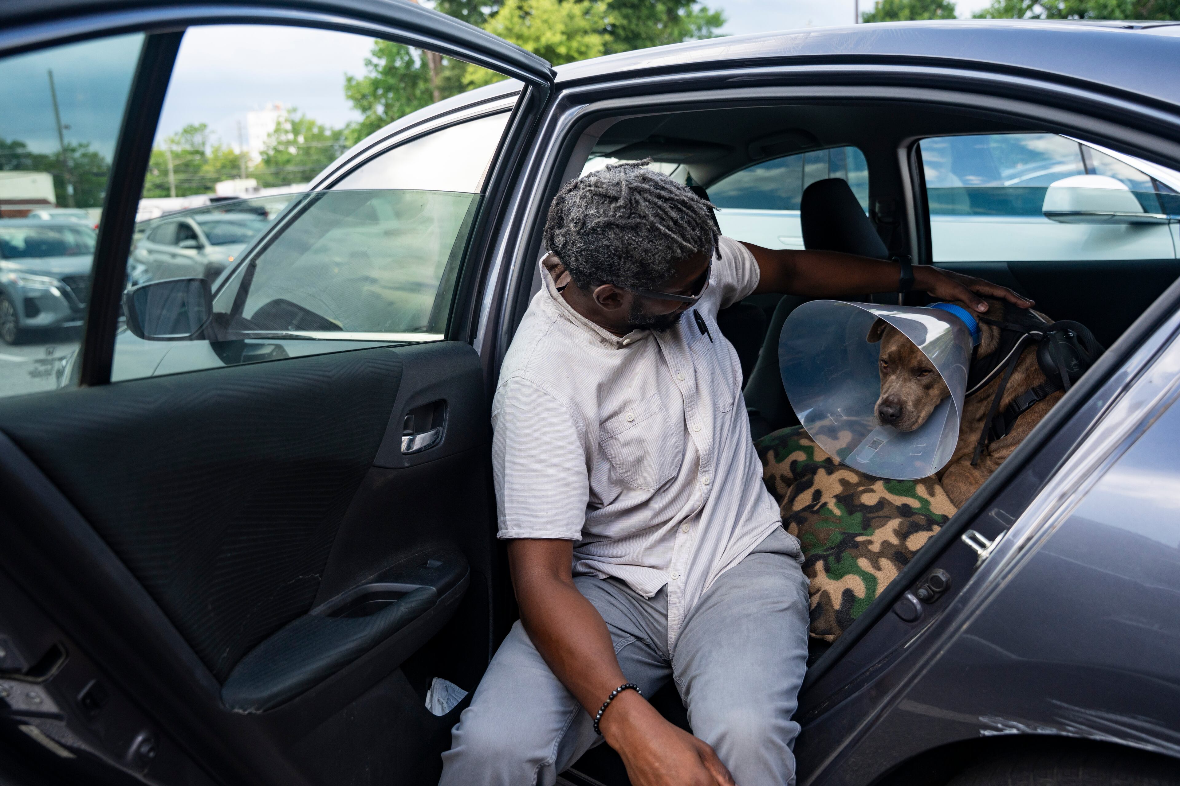 Zach Jackson gets his new dog, Pomelo, ready to go home from the DeKalb Animal Shelter on Tuesday, July 1, 2025, in Chamblee. (Olivia Bowdoin for the AJC)