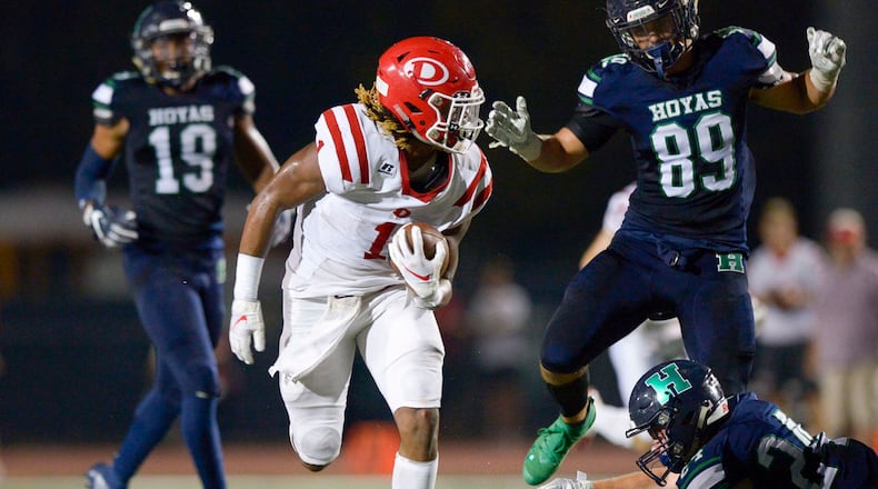 Dalton running back Jahmyr Gibbs (1) avoids Harrison's  defense as he gains yardage in the first half of their game Friday, Sept. 27, 2019, at Harrison High.