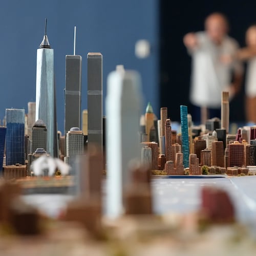 Lower Manhattan, featuring both the One World Trade and the Twin Towers, is seen on a large model of the New York City, made by Joe Macken, at the Museum of the City of New York in New York, Monday, Sept. 14, 2026. (AP Photo/Seth Wenig)