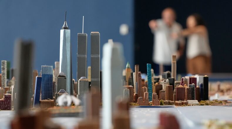 Lower Manhattan, featuring both the One World Trade and the Twin Towers, is seen on a large model of the New York City, made by Joe Macken, at the Museum of the City of New York in New York, Monday, Sept. 14, 2026. (AP Photo/Seth Wenig)