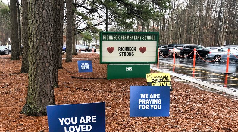 FILE - Signs stand outside Richneck Elementary School in Newport News, Va., Jan. 25, 2023. (AP Photo/Denise Lavoie, File)