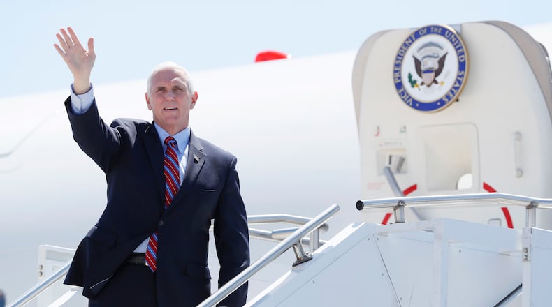 Vice President Mike Pence waves as he stops off Air Force Two after arriving at the Des Moines International Airport before meeting with faith leaders and food industry executives in response to the coronavirus pandemic, Friday, May 8, 2020, in Des Moines, Iowa. (AP Photo/Charlie Neibergall)