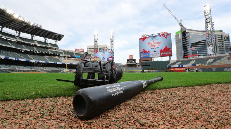 Atlanta Braves Freddie Freeman’s bat and glove sit on the field at the team’s new stadium at SunTrust Park.