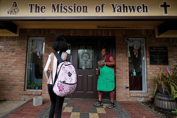 Crystal Holmes, right, greets her granddaughter, Mackenzie Holmes, 10, as she arrives at Mission of Yahweh women's shelter after school on Tuesday, April 1, 2025, in Houston. (AP Photo/Ashley Landis)