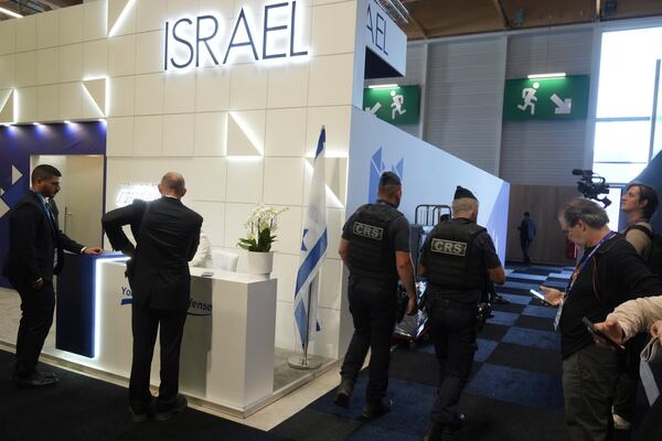 Riot police officers patrol by the Israeli pavilions at the Paris Air Show , Monday, June 16, 2025 in Le Bourget, north of Paris. (AP Photo/Michel Euler)