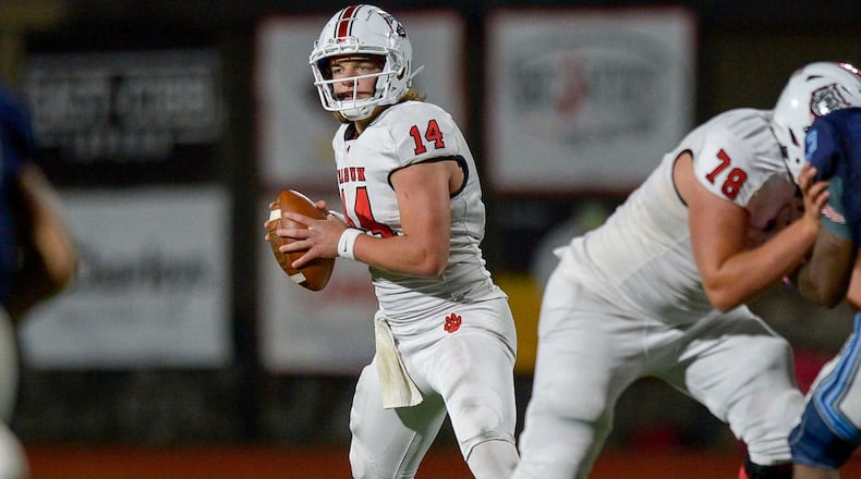 Rabun County quarterback Gunner Stockton (14) looks for a receiver during the second half of Friday's game against Pope.