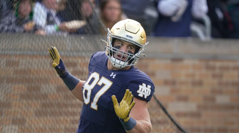 Notre Dame's Michael Mayer (87) reacts following a touchdown reception during the first half of an NCAA college football game against Georgia Tech, Saturday, Nov. 20, 2021, in South Bend, Ind. (AP Photo/Darron Cummings)