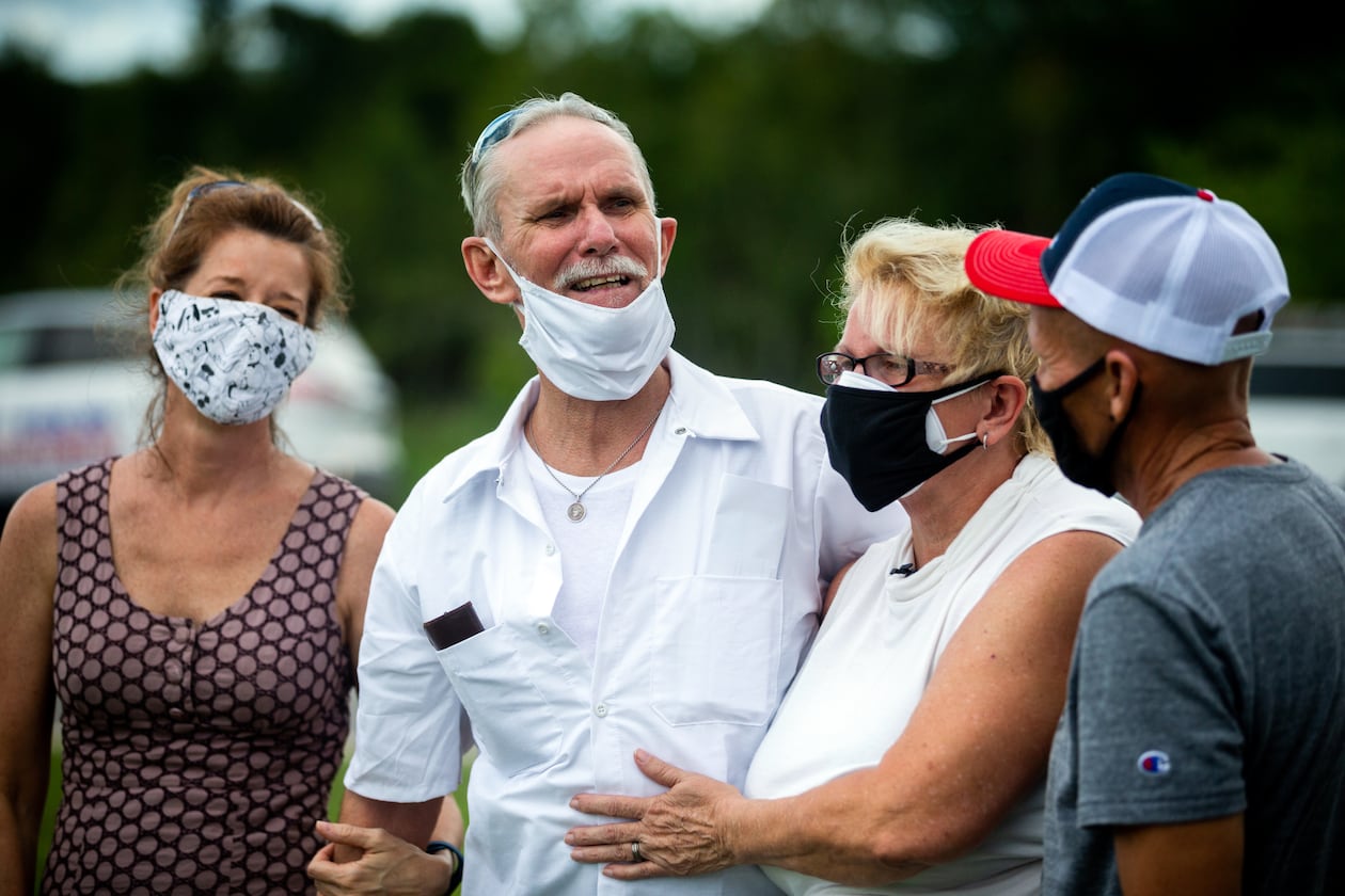 Dennis Perry, center, standing beside wife Brenda Perry gets emotional while thanking the team from the Georgia Innocence Project after they worked to get his release from 20 years behind bars, Thursday, July 23, 2020, in Nicholls, Ga. (Stephen B. Morton for The Atlanta Journal-Constitution)