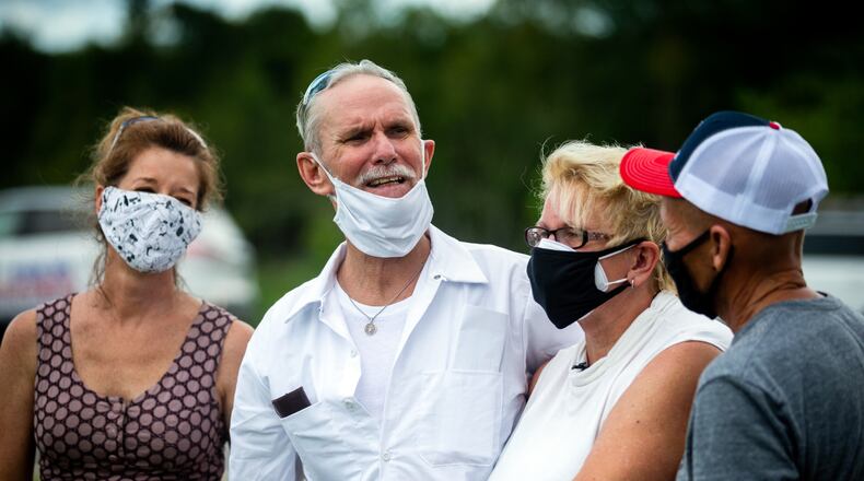 Dennis Perry, center, standing beside wife Brenda Perry gets emotional while thanking the team from the Georgia Innocence Project after they worked to get his release from 20 years behind bars, Thursday, July 23, 2020, in Nicholls, Ga. (Stephen B. Morton for The Atlanta Journal-Constitution)