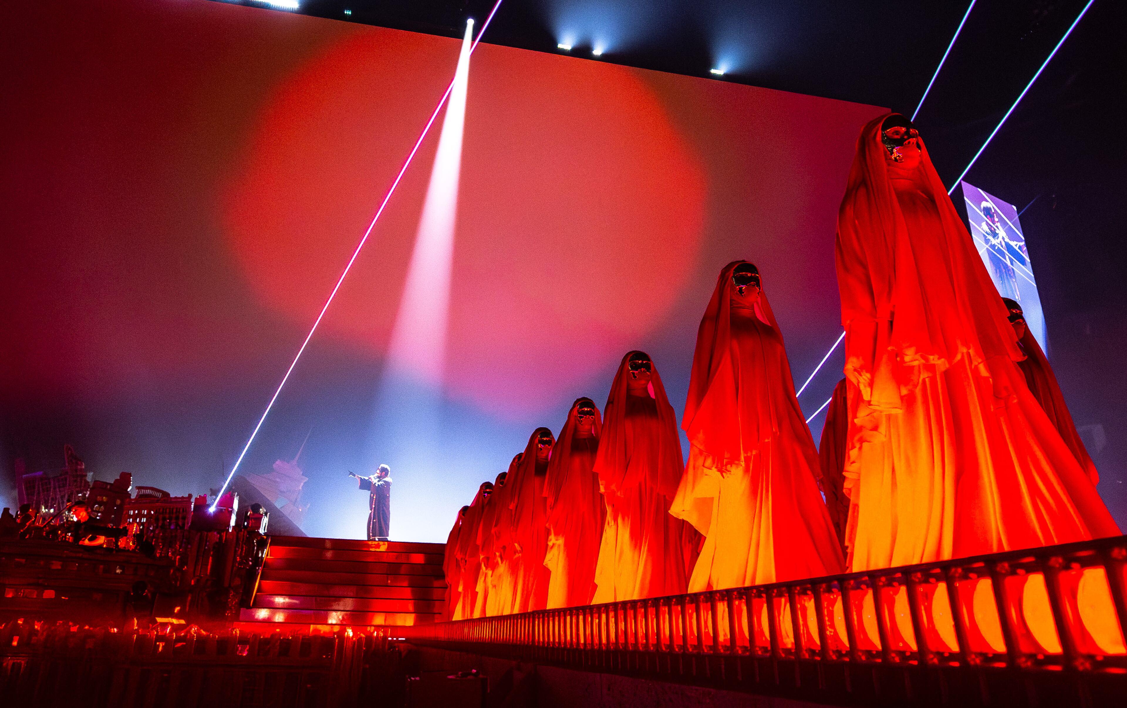 Over a dozen dancers dressed in bright red robes perform with The Weeknd during his concert at Mercedes-Benz Stadium on Thursday, Aug. 21, 2025, in Atlanta. (Ryan Fleisher for the AJC)