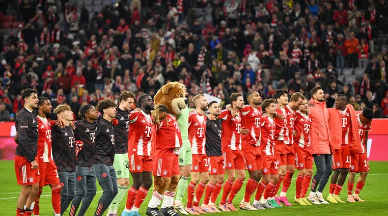 Bayern Munich players celebrate their victory after the Bundesliga soccer match between Bayern Munich and Borussia Dortmund in Munich, Germany, Saturday, Oct. 18, 2025. (AP Photo/Lennart Preiss)