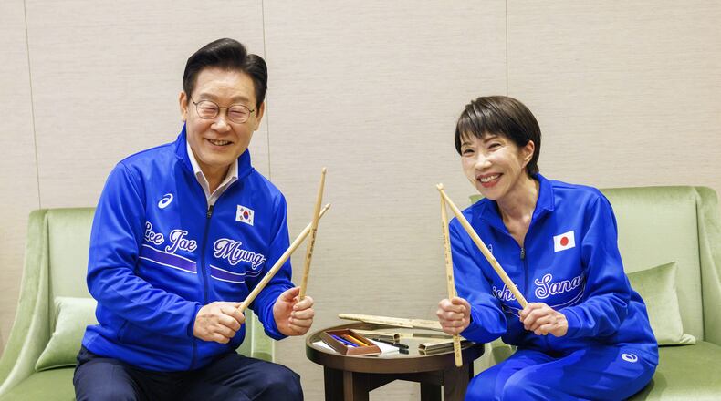 In this photo released on the official website of Prime Minister's Office of Japan, Japanese Prime Minister Sanae Takaichi, right, and South Korean President Lee Jae Myung pose for a photo as they play drump together after their talks in Nara, western Japan Tuesday, Jan. 13, 2026. (Prime Minister's Office of Japan via AP)