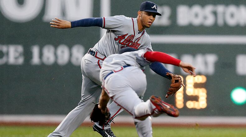 Braves shortstop Andrelton Simmons (left) was out of the lineup Tuesday in Boston after being hit in the right hand by a pitch Monday night.