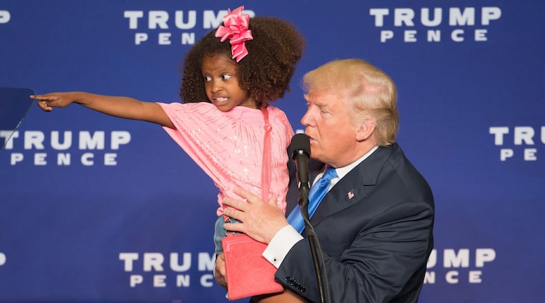 Republican presidential nominee Donald Trump holds a child as he speaks during a rally at the KI Convention Center on October 17, 2016 in Green Bay, Wisconsin. / AFP / Tasos Katopodis (TASOS KATOPODIS/AFP/Getty Images)