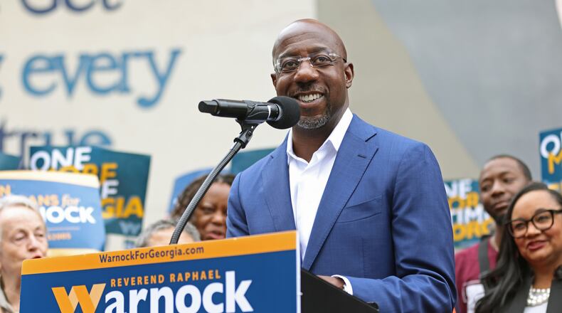 Democratic nominee for U.S Senate Sen. Raphael Warnock speaks at the site of the John Lewis mural, Thursday, Nov. 10, 2022, in Atlanta. Warnock is in a runoff with republican nominee Herschel Walker on Dec. 6, 2022. (Jason Getz/The Atlanta Journal-Constitution/TNS)