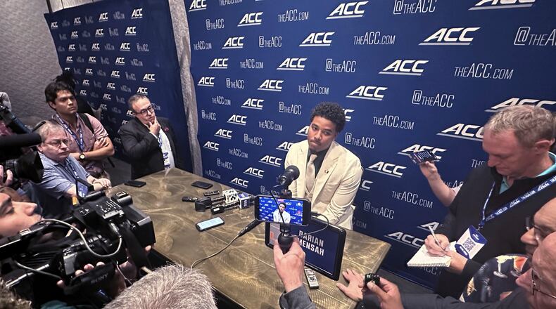Miami quarterback Darian Mensah listens during ACC Kickoff preseason football media days, Wednesday, July 15, 2026 in Charlotte, N.C. (AP Photo/Aaron Beard)