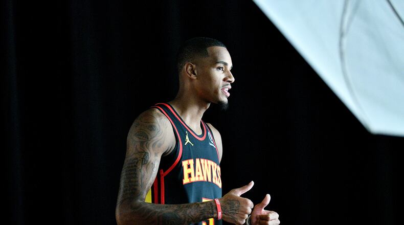 Hawks guard Dejounte Murray gives a thumbs-up during a photo shoot. (Hyosub Shin / Hyosub.Shin@ajc.com)