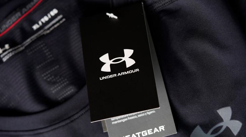 FILE - The company logo graces a sales tag on a compression shirt for sale in an Under Armour store in an outlet mall on May 3, 2021, in Lakewood, Colo. (AP Photo/David Zalubowski, File)
