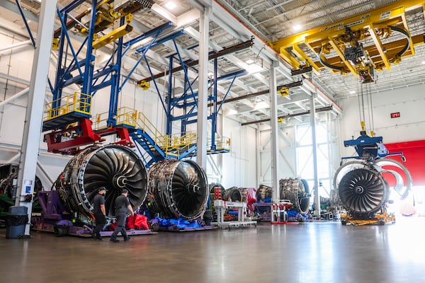 Delta workers walk through the shop floor past engines in for maintenance work at the Delta TechOps campus in Atlanta on Tuesday, November 18, 2025. (Abbey Cutrer/AJC)