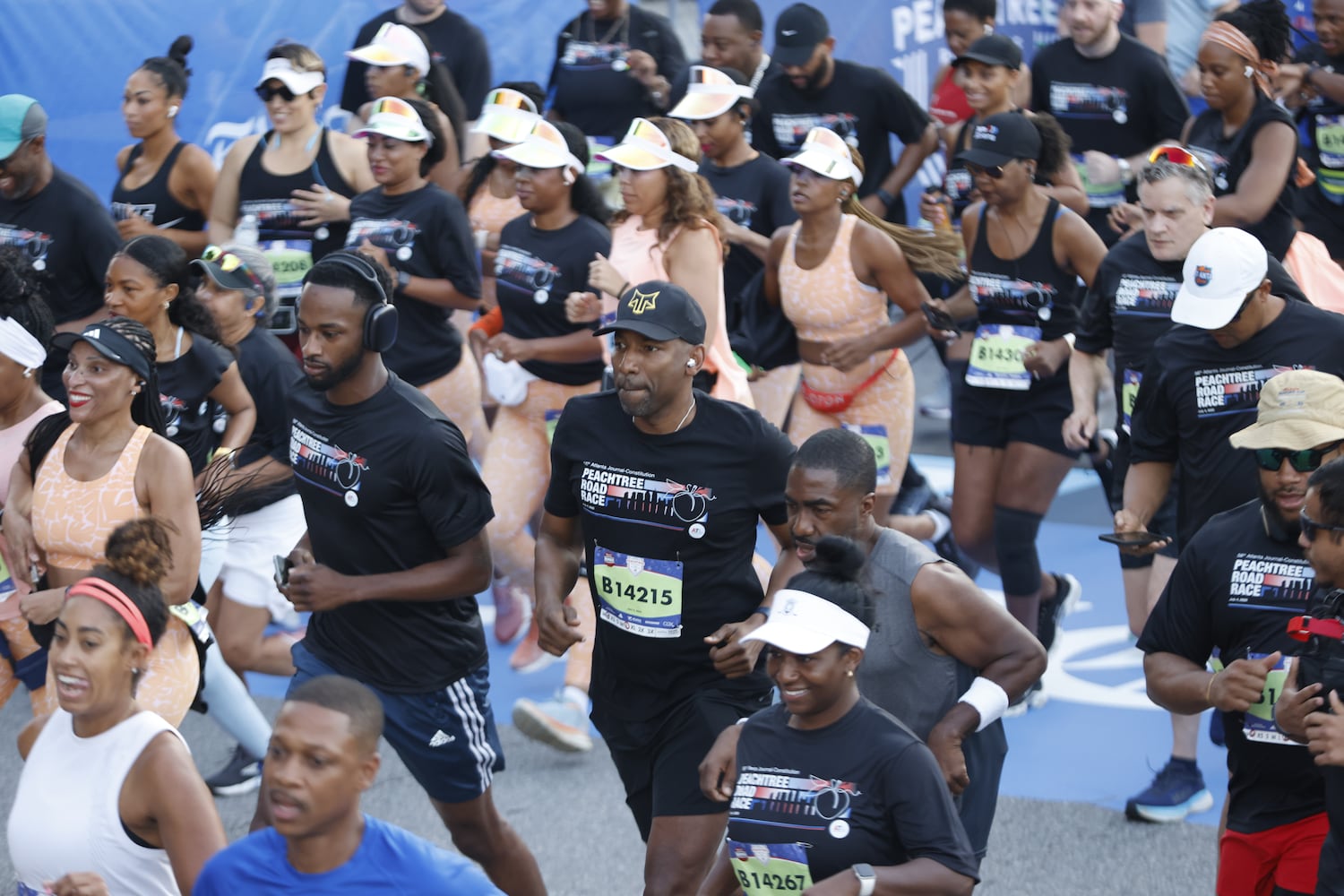 Mayor Andre Dickens (center) starts off the 56th AJC Peachtree Road Race on Friday, July 4, 2025, in Atlanta. (Arvin Temkar/AJC)