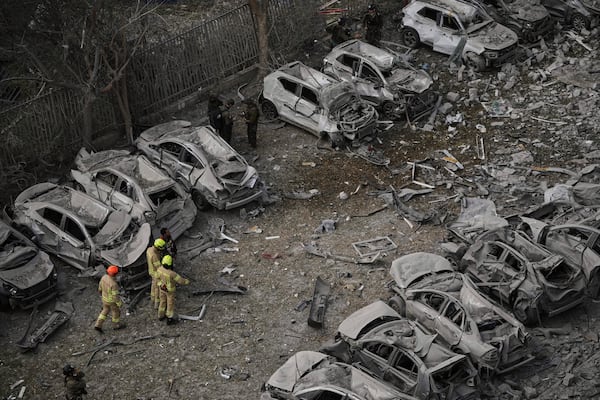 Firefighters inspect the site struck by an Iranian missile strike that killed several people, in Beersheba, Israel, on Tuesday, June 24, 2025. (AP Photo/Leo Correa)