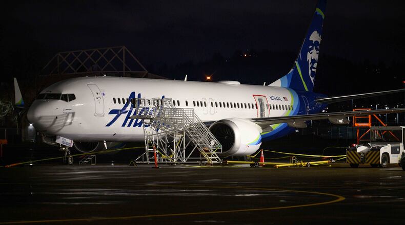 A plastic sheet covers an area of the fuselage of the Alaska Airlines N704AL Boeing 737 MAX 9 aircraft outside a hangar at Portland International Airport on Jan. 8, 2024, in Portland, Oregon, following a midair fuselage blowout on Jan. 5. None of the 171 passengers and six crew members were seriously injured. (Mathieu Lewis-Rolland/Getty Images/TNS)