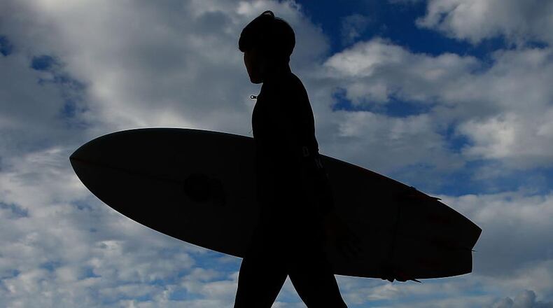 A California man surfed through a flooded street after heavy rains this week.
