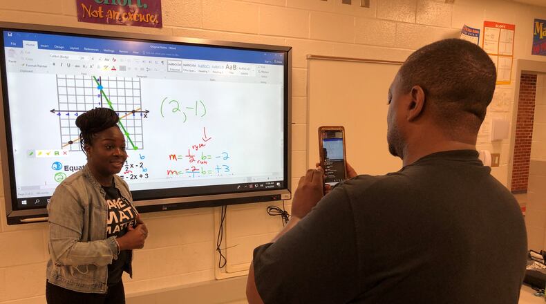 North Clayton Middle School eighth-grade math teachers Alisha Rosser and Carlos Johnson offer online instruction to students of the school Monday. The district, like most across metro Atlanta, closed schools indefinitely as the nation grapples with the coronavirus outbreak.