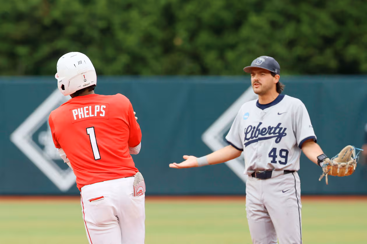 Liberty Flames infielder Easton Swofford (49) argues with Georgia Bulldogs infielder Tre Phelps (1) as he runds the bases after hitting a two-run home run during the sixth inning of their NCAA Regional final game at Foley Field on Sunday, May 31, 2026, in Athens. Tre Phelps was later ejected for excessive celebration. (Miguel Martinez/AJC)