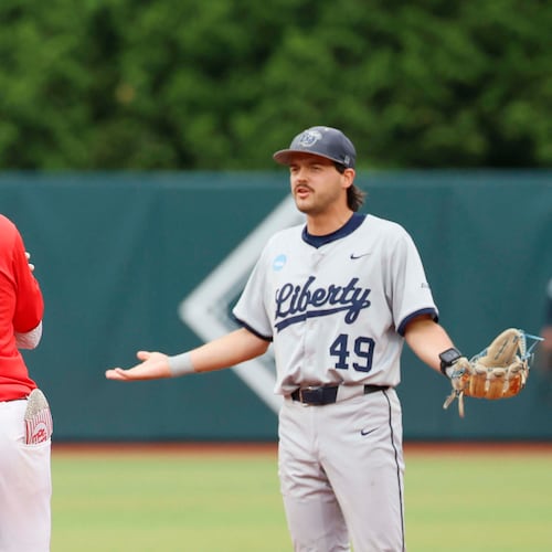 Liberty Flames infielder Easton Swofford (49) argues with Georgia Bulldogs infielder Tre Phelps (1) as he runds the bases after hitting a two-run home run during the sixth inning of their NCAA Regional final game at Foley Field on Sunday, May 31, 2026, in Athens. Tre Phelps was later ejected for excessive celebration. (Miguel Martinez/AJC)