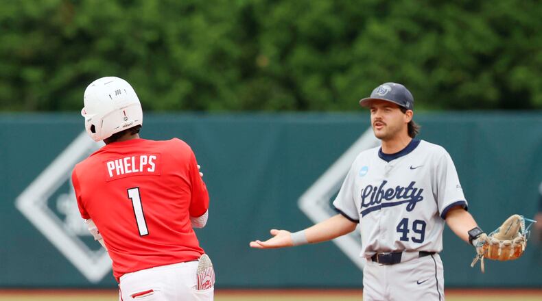 Liberty Flames infielder Easton Swofford (49) argues with Georgia Bulldogs infielder Tre Phelps (1) as he runds the bases after hitting a two-run home run during the sixth inning of their NCAA Regional final game at Foley Field on Sunday, May 31, 2026, in Athens. Tre Phelps was later ejected for excessive celebration. (Miguel Martinez/AJC)