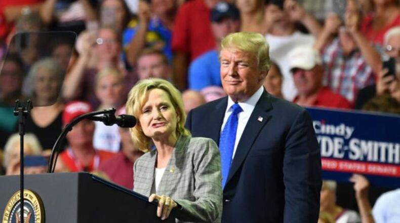 Mississippi Sen. Cindy Hyde-Smith (L) stands on stage with President Donald Trump at a “Make America Great Again” rally at Landers Center in Southaven, Mississippi, on October 2, 2018.