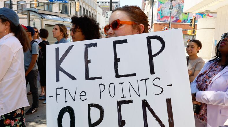 Parker Thornton with the Central Atlanta Progress organization holds a sign as the city leader speaks during a press conference outside Five Points stations on Tuesday, June 25, 2025, opposing the station’s closure for renovations.
(Miguel Martinez / AJC)
